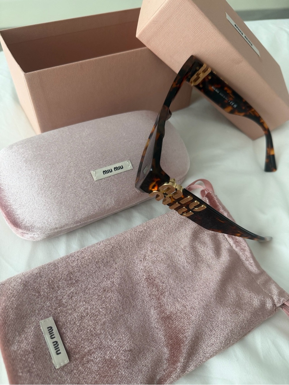 Miu Miu Tortoiseshell Sunglasses with Gold Chain Logo Detail